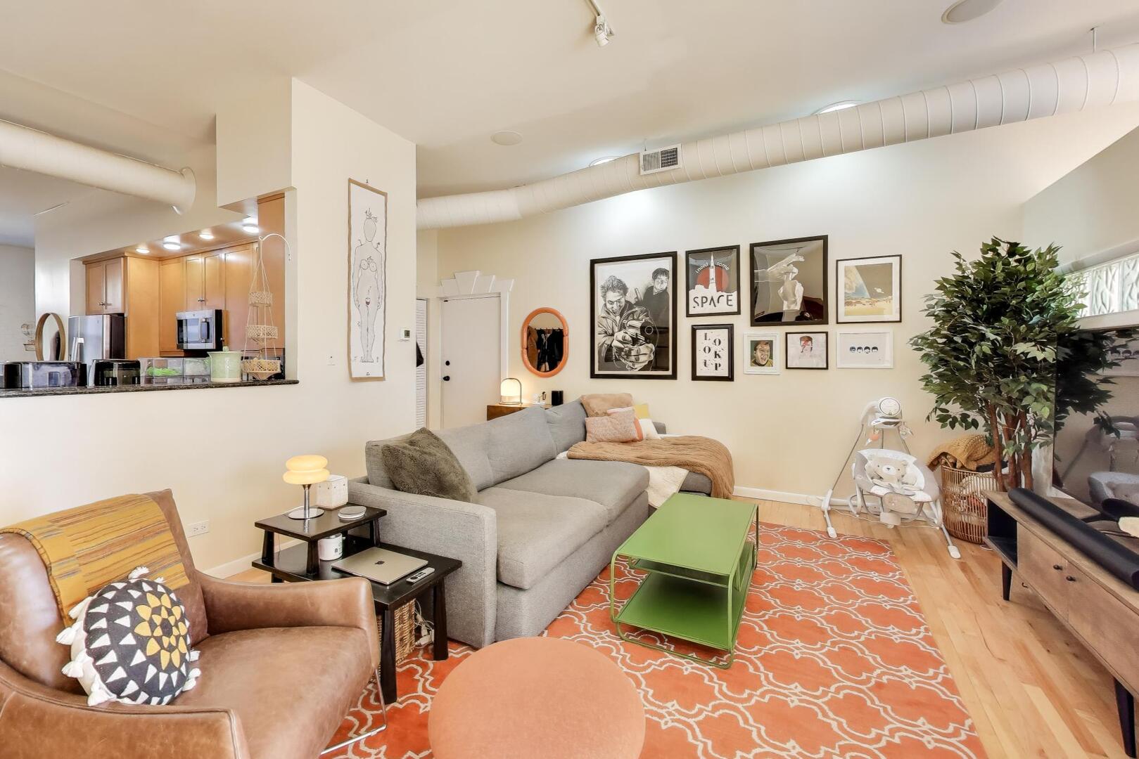 400 North Racine Avenue, Unit 204 Chicago, IL 60642 - Photo 11 of 28 a living room with furniture and a wooden floor