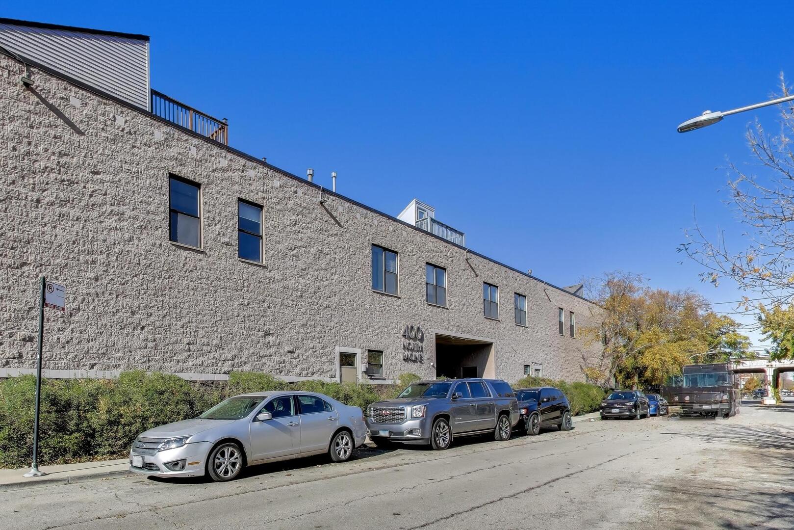 400 North Racine Avenue, Unit 204 Chicago, IL 60642 - Photo 2 of 28 a car parked in front of a building
