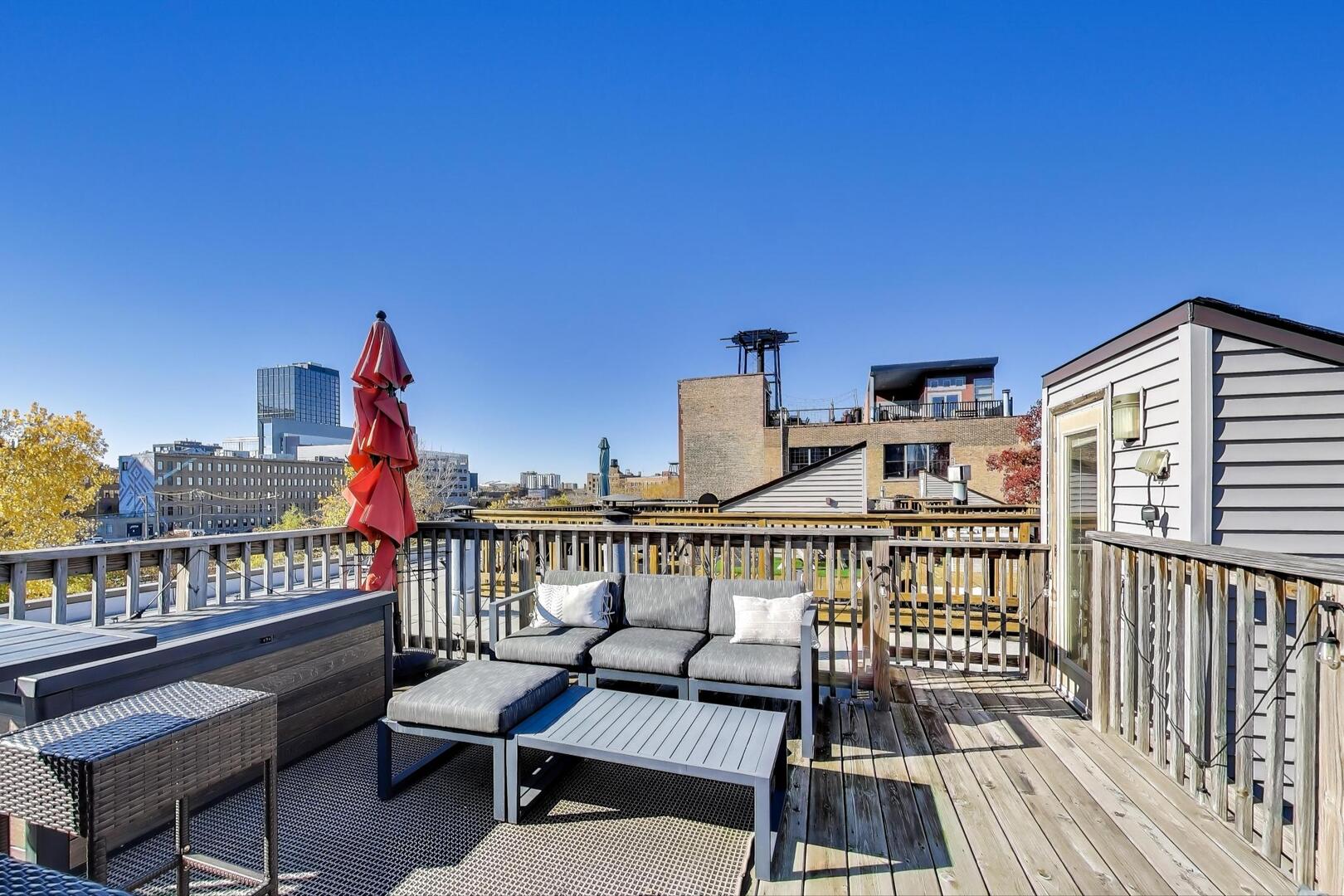 400 North Racine Avenue, Unit 204 Chicago, IL 60642 - Photo 26 of 28 a view of a balcony with two chairs and a wooden floor