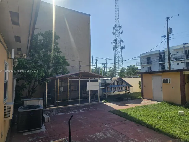 a view of a house with a backyard and balcony