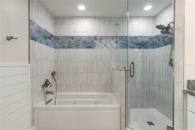 a bathroom with a shower and a tub