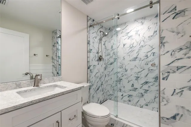 a bathroom with a sink toilet and shower