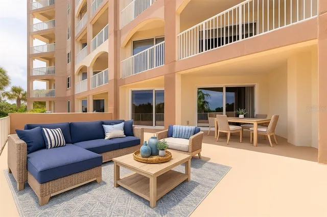 a view of a patio with couches and a potted plant on a table