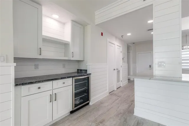 a view of a kitchen with white cabinets