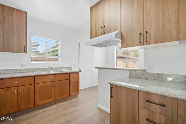 a spacious bathroom with a granite countertop sink and a mirror