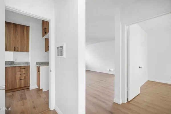 a view of hallway with wooden floor