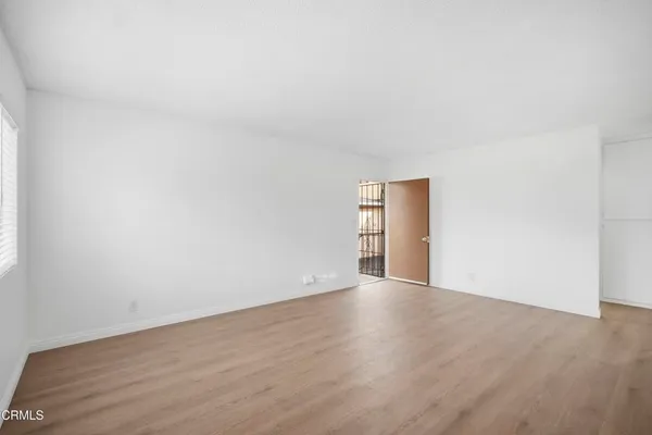 a view of an empty room and wooden floor