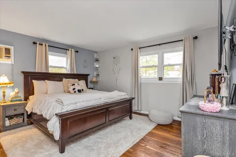 a bedroom with a bed and window