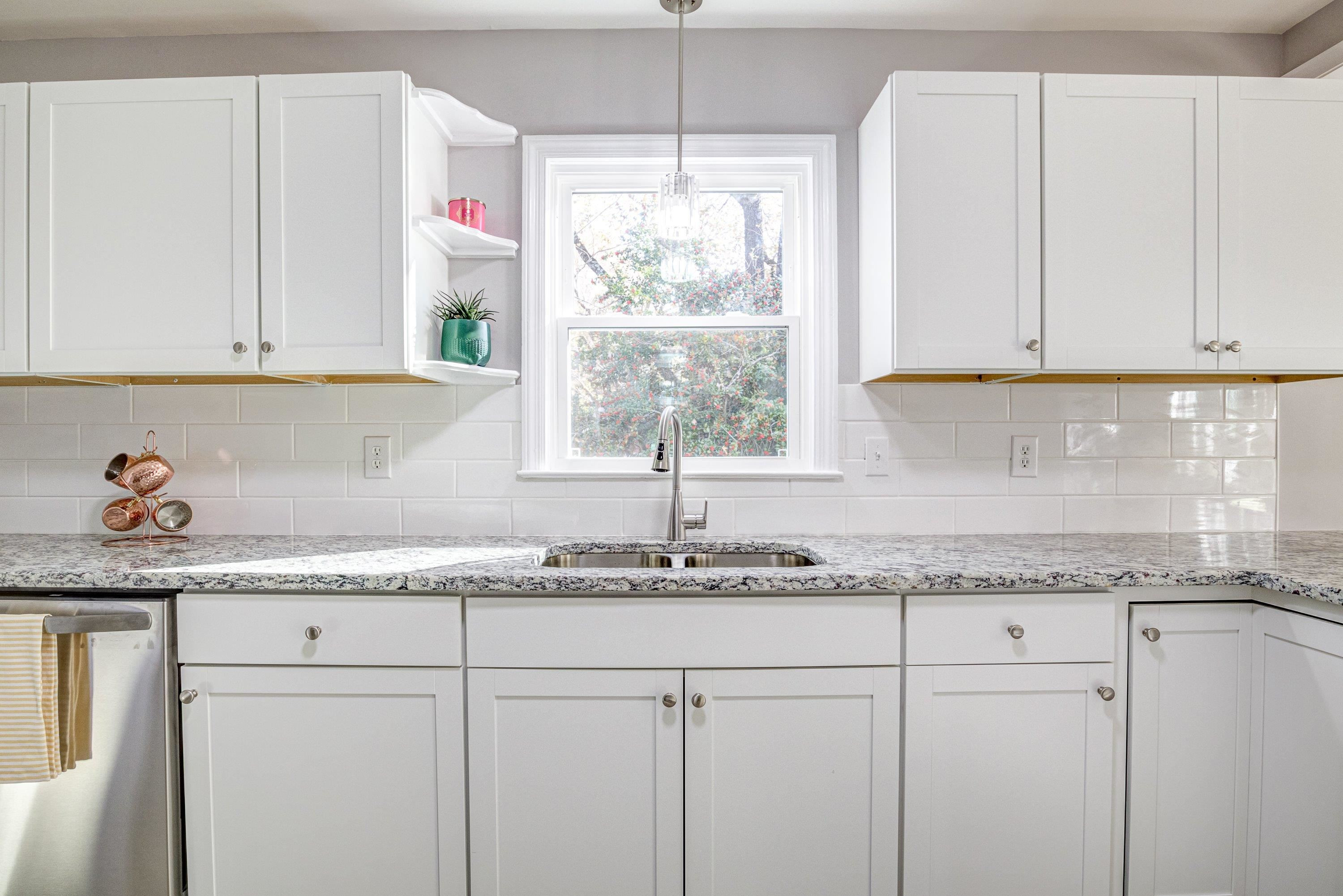 1111 Southerlund Road Garner, NC 27529 - Photo 14 of 29 a kitchen with granite countertop white cabinets and a window
