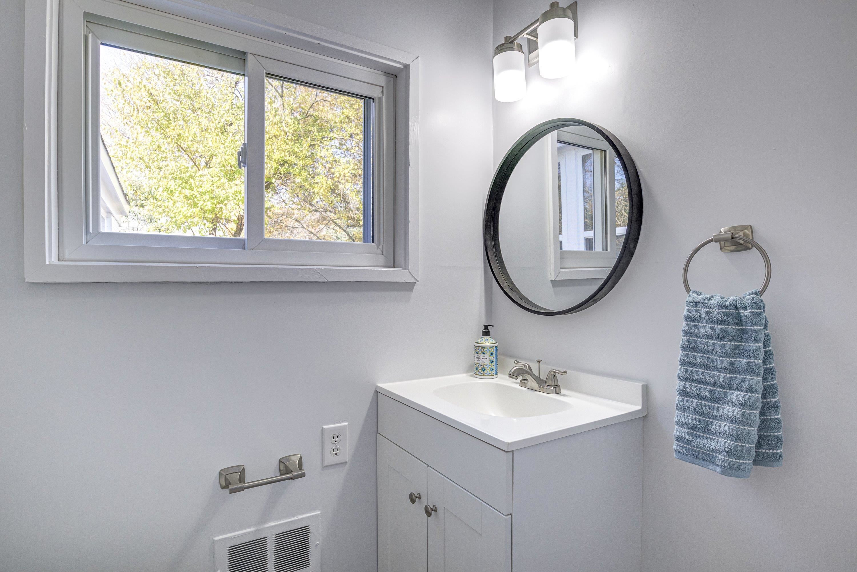 1111 Southerlund Road Garner, NC 27529 - Photo 18 of 29 a bathroom with a sink and a mirror