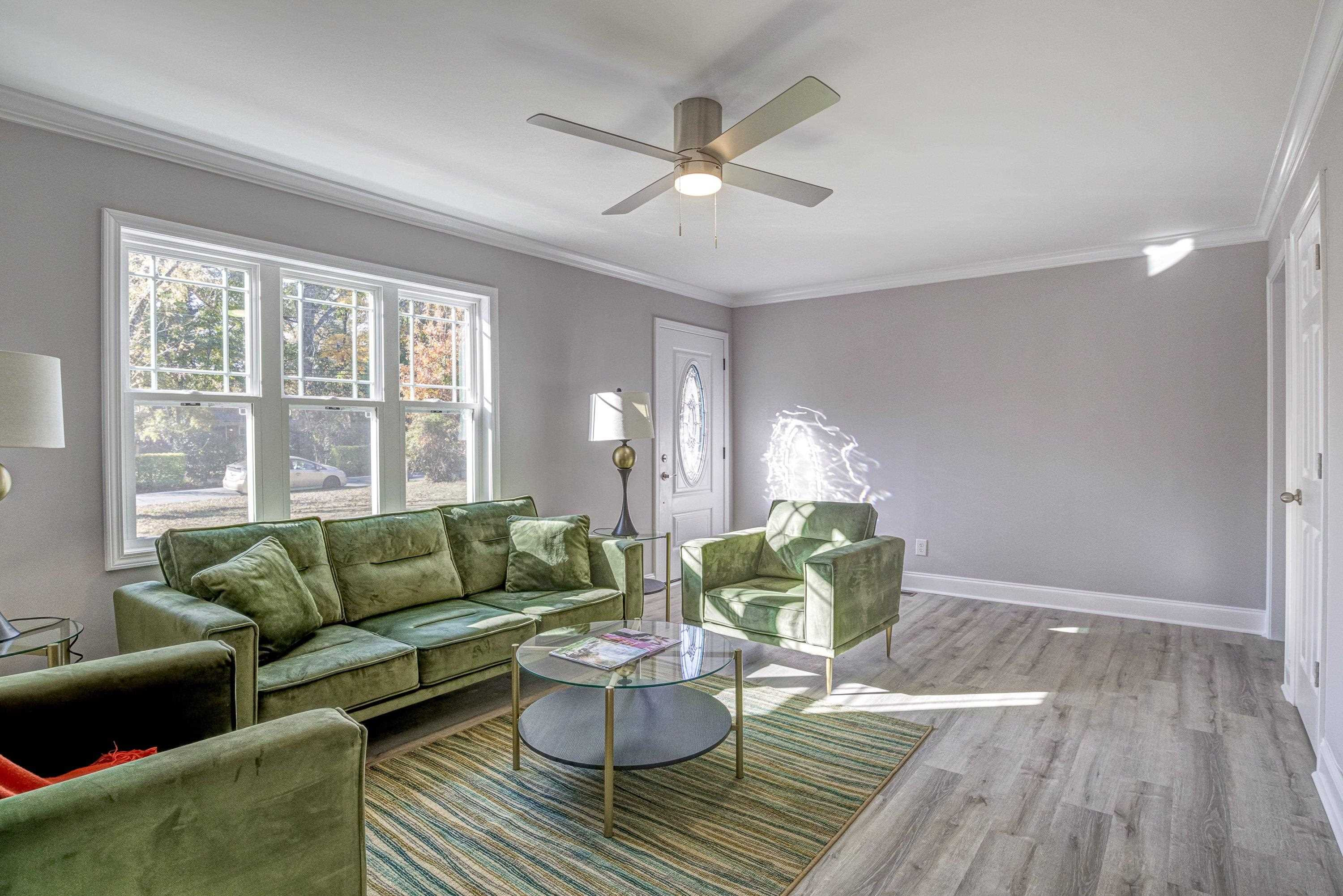 1111 Southerlund Road Garner, NC 27529 - Photo 5 of 29 a living room with furniture and a large window