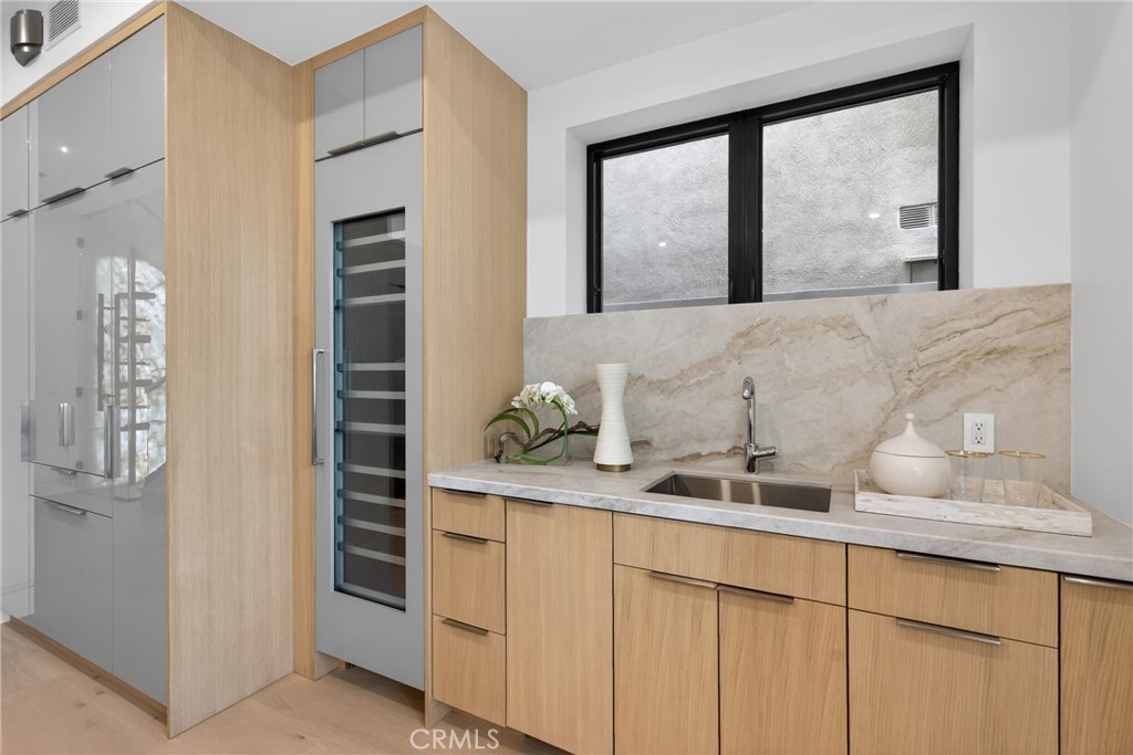 520 11th Street Huntington Beach, CA 92648 - Photo 18 of 65 a kitchen with a sink and cabinets