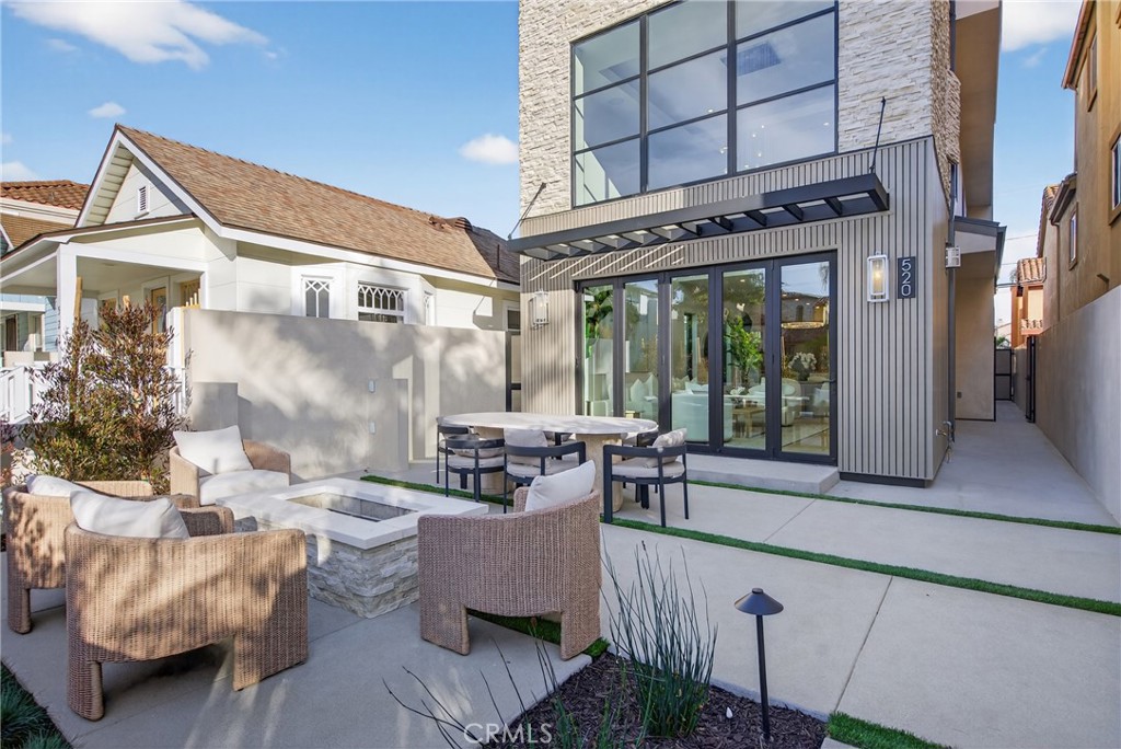 520 11th Street Huntington Beach, CA 92648 - Photo 2 of 65 a building outdoor space with patio furniture and potted plants