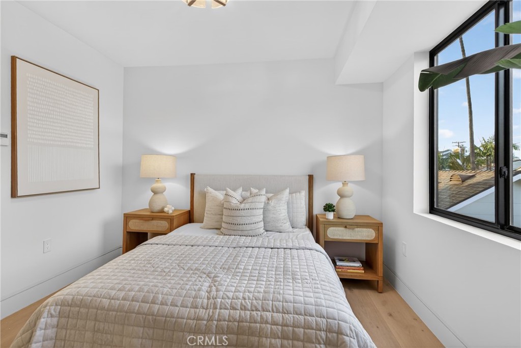 520 11th Street Huntington Beach, CA 92648 - Photo 26 of 65 a bedroom with a bed and window