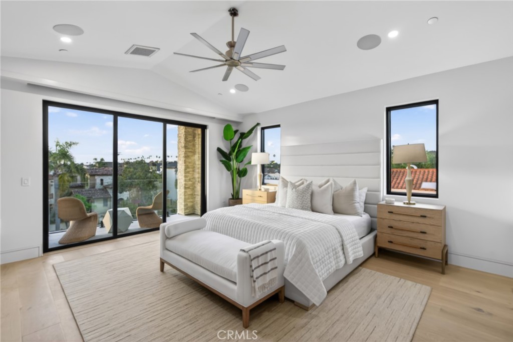 520 11th Street Huntington Beach, CA 92648 - Photo 32 of 65 a bedroom with a large bed and a chandelier