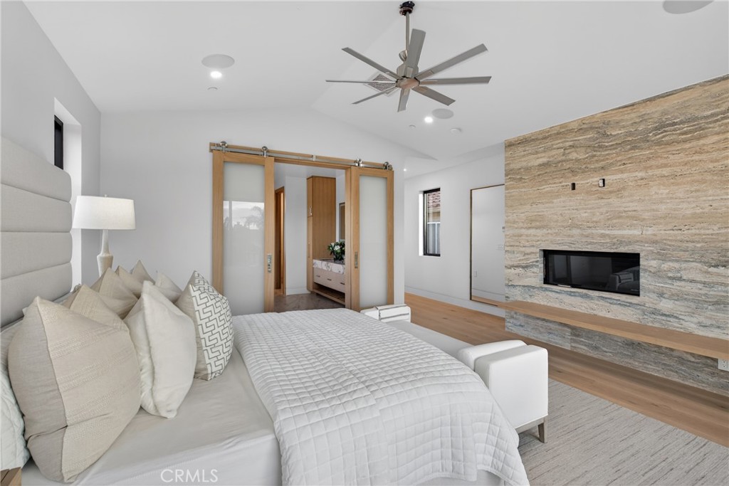 520 11th Street Huntington Beach, CA 92648 - Photo 33 of 65 a spacious bedroom with a large bed and a fireplace