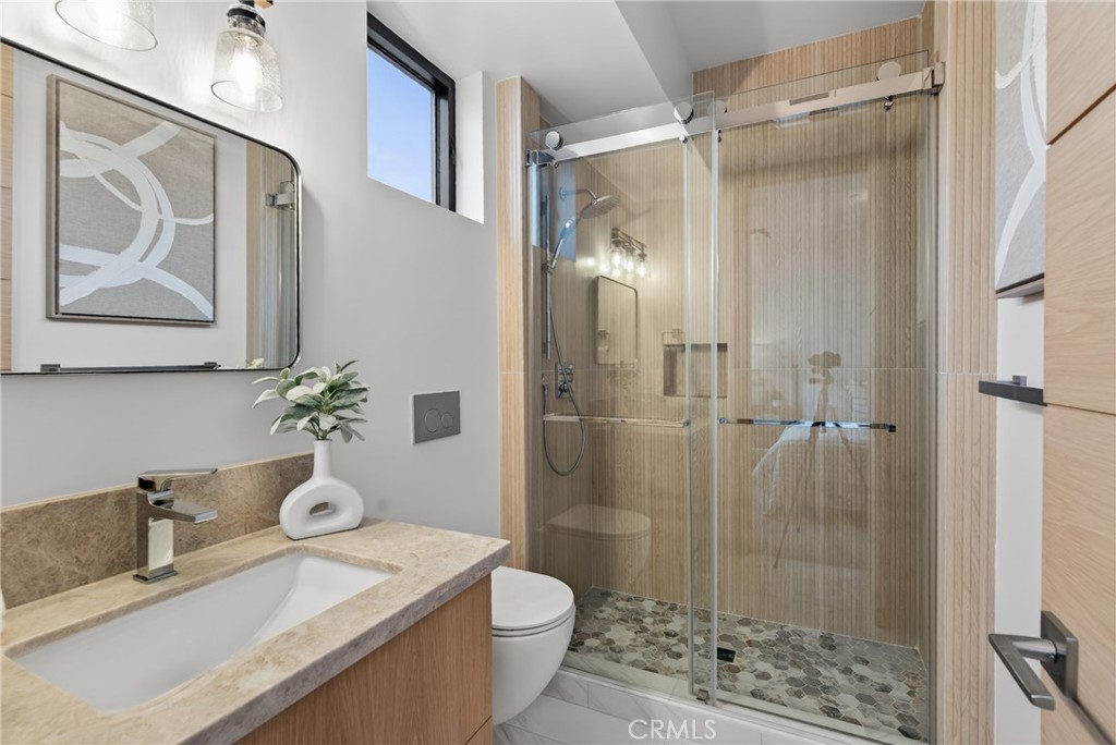 520 11th Street Huntington Beach, CA 92648 - Photo 35 of 65 a bathroom with a granite countertop sink toilet and shower