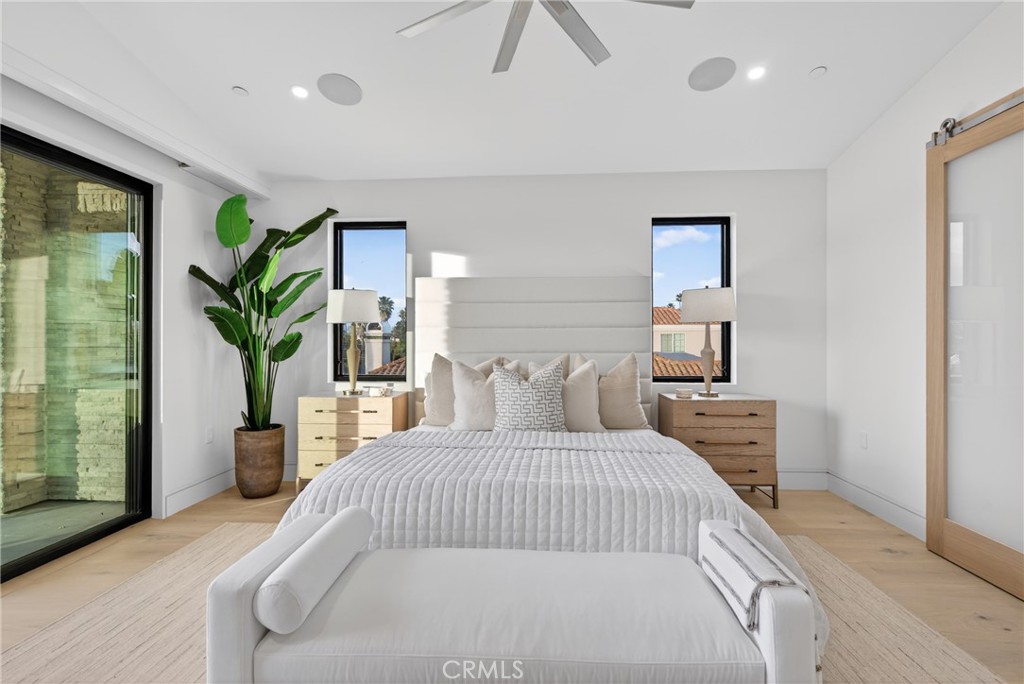 520 11th Street Huntington Beach, CA 92648 - Photo 37 of 65 a bedroom with a large bed and a potted plant