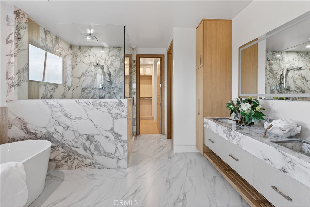 520 11th Street Huntington Beach, CA 92648 - Photo 39 of 65 a spacious bathroom with a granite countertop tub sink and mirror