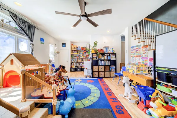 a living room with patio furniture and a book shelf