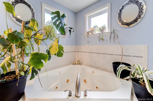 a bathroom with a sink a mirror and a bathtub