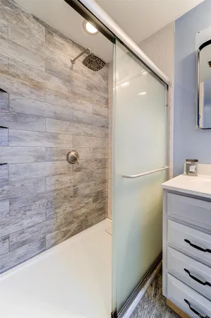 a bathroom with a shower and a sink