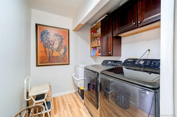 a kitchen that has a sink and a stove with wooden floor