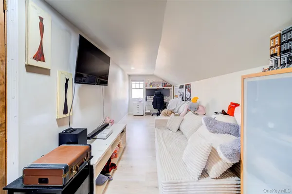 a bedroom with furniture and a flat screen tv