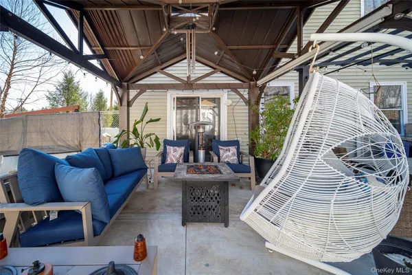 a view of patio with a table and chairs