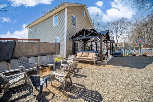 a view of a patio with table and chairs with wooden floor and fence