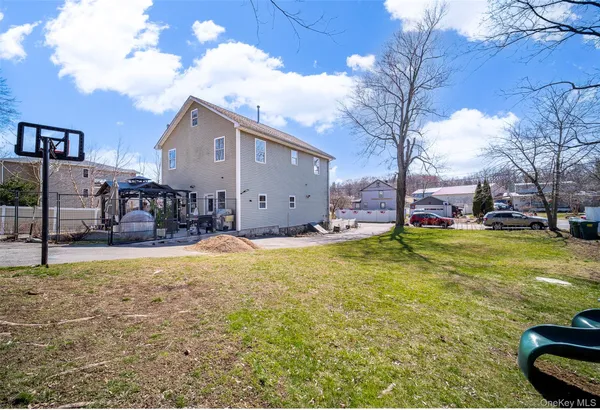 a view of a house with a yard covered with snow