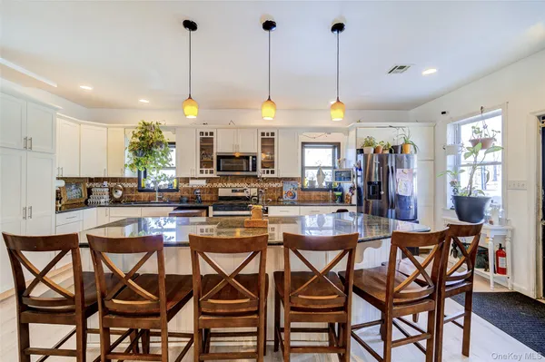 a dining table chairs and a kitchen view