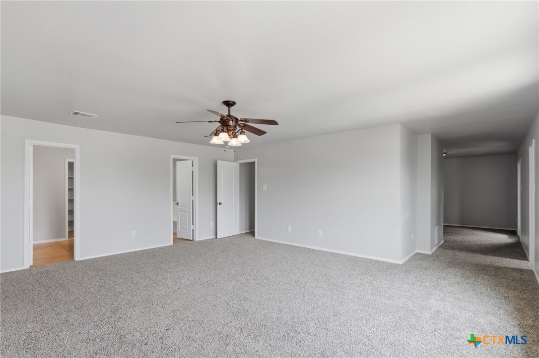 8716 Starview Street Temple, TX 76502 - Photo 13 of 36 Bright and airy primary bedroom with plush carpeting, ready for your personal touch. Be creative with your nook.