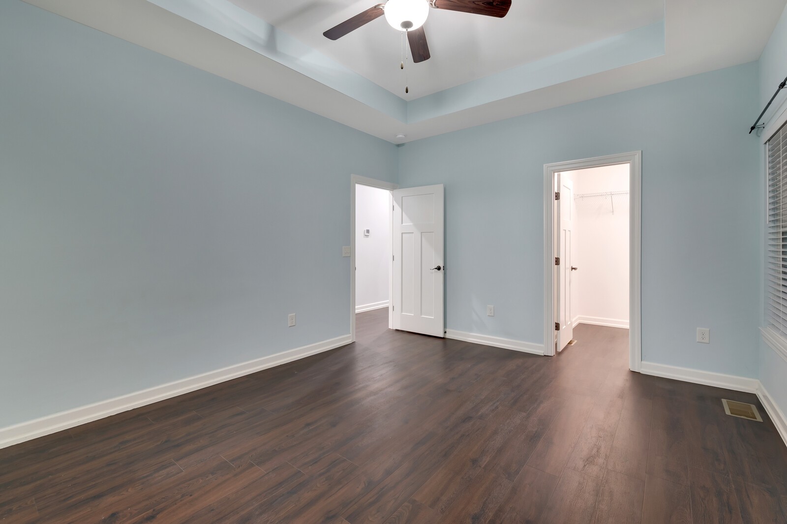 105 Lake Wood Road Lebanon, TN 37087 - Photo 11 of 34 an empty room with wooden floor chandelier fan and windows