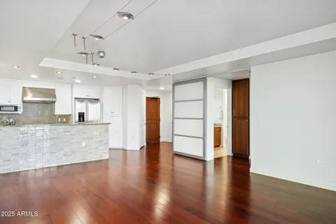 a view of a room with wooden floor and cabinet