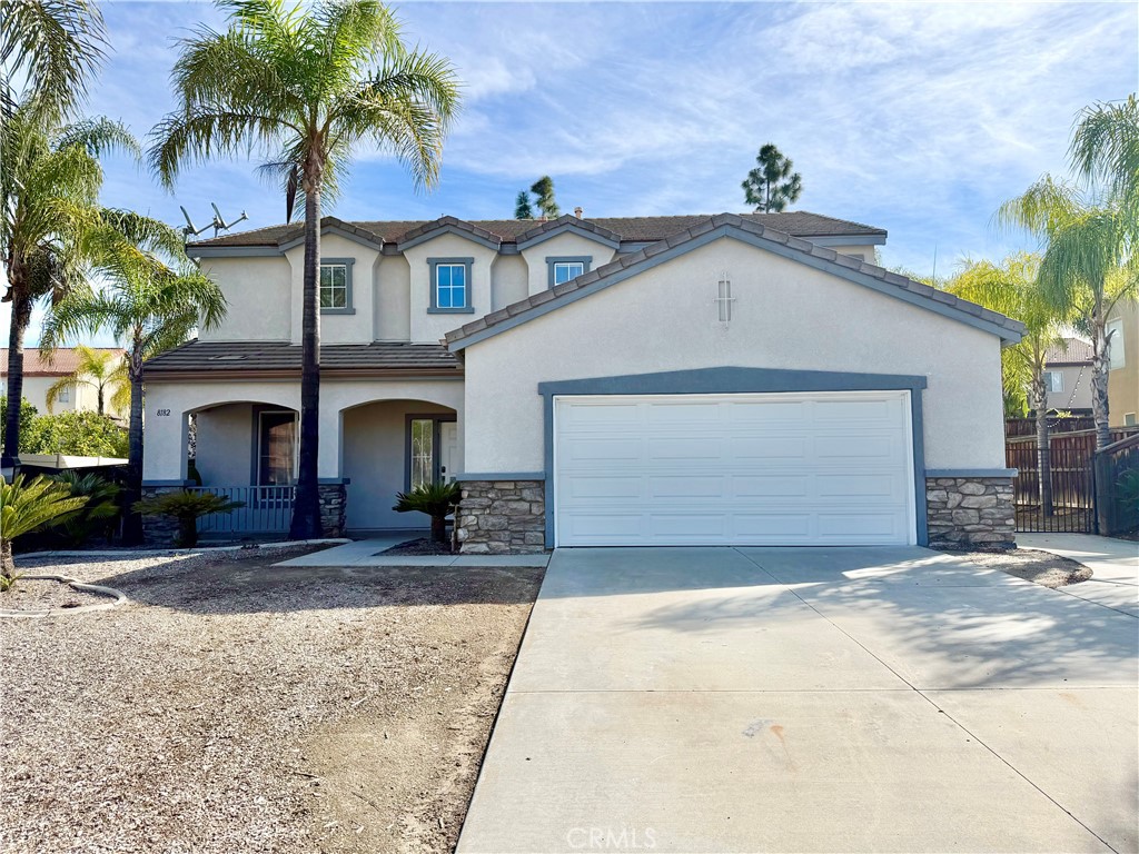 8182 Bon View Drive Riverside, CA 92508 - Photo 1 of 43 a front view of a house with a yard and garage
