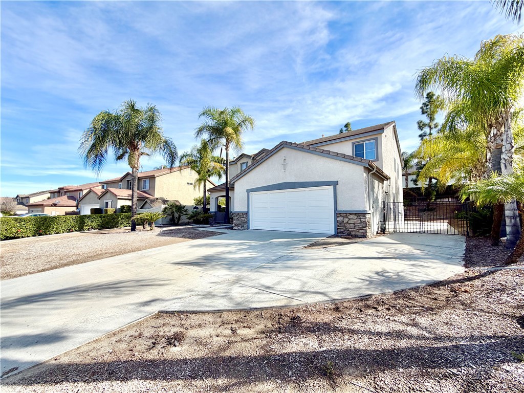 8182 Bon View Drive Riverside, CA 92508 - Photo 2 of 43 a view of a house with a yard and garage