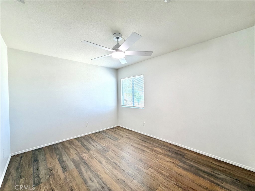8182 Bon View Drive Riverside, CA 92508 - Photo 24 of 43 an empty room with a window and a ceiling fan