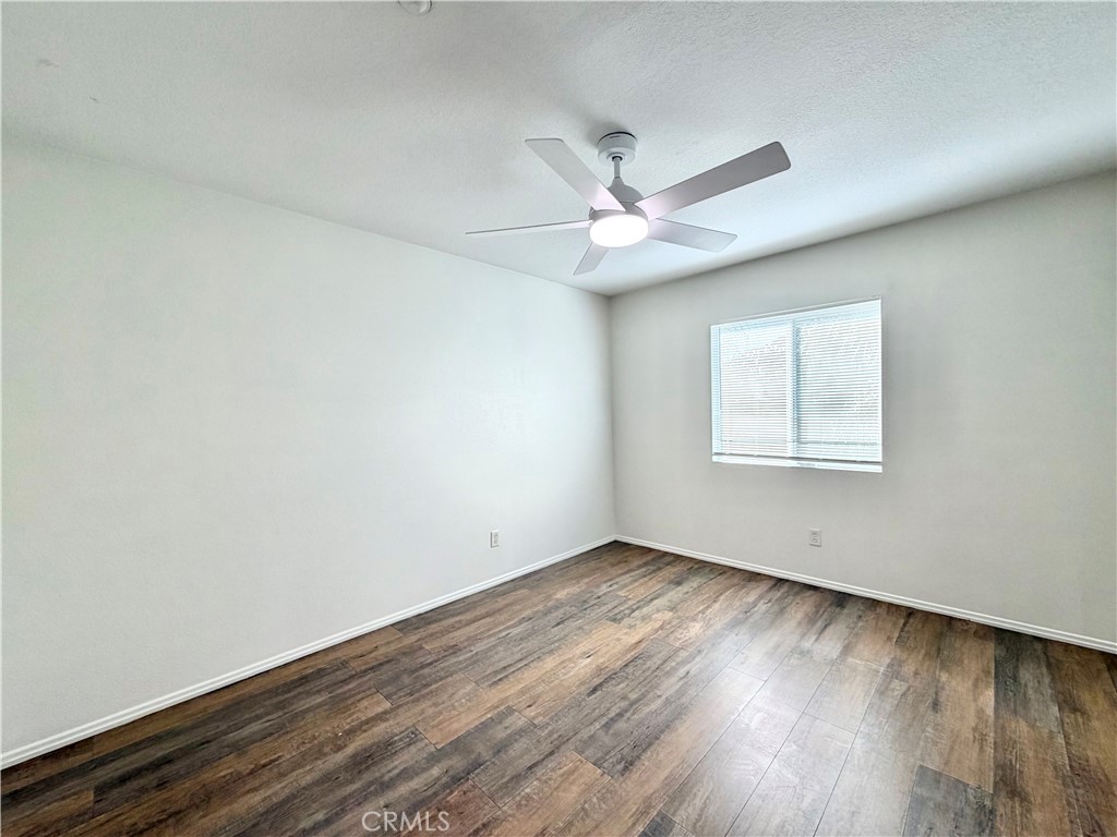 8182 Bon View Drive Riverside, CA 92508 - Photo 26 of 43 an empty room with wooden floor and windows