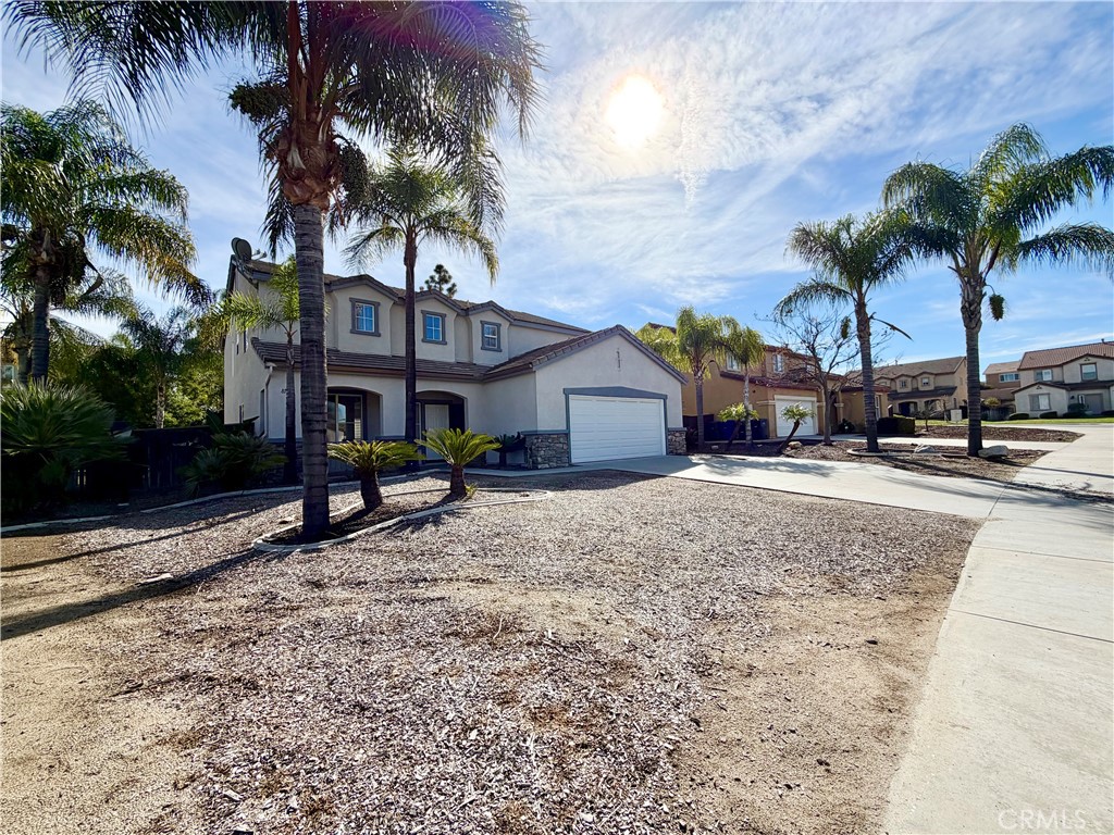 8182 Bon View Drive Riverside, CA 92508 - Photo 3 of 43 a view of a house with a yard and palm trees