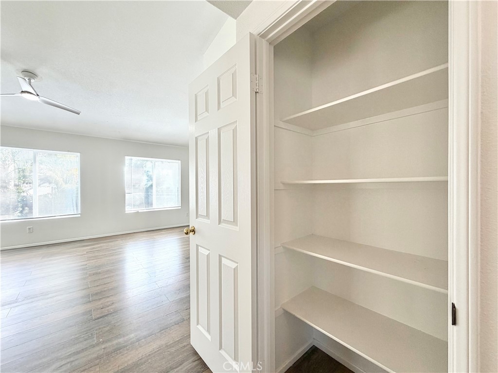 8182 Bon View Drive Riverside, CA 92508 - Photo 33 of 43 a view of an empty room with wooden floor and windows