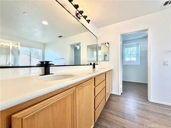 a bathroom with a double vanity sink and mirror
