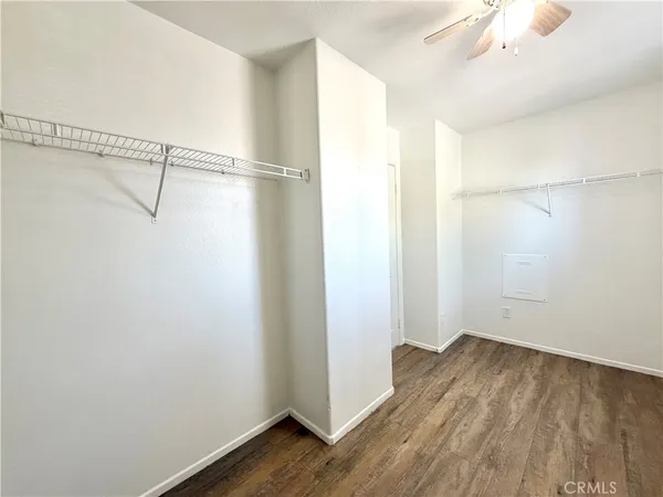 a view of a room with wooden floor