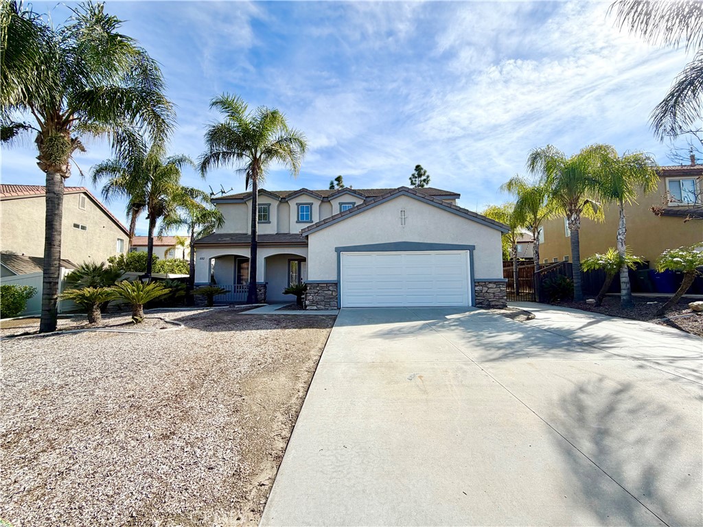 8182 Bon View Drive Riverside, CA 92508 - Photo 4 of 43 a front view of a house with a yard and garage