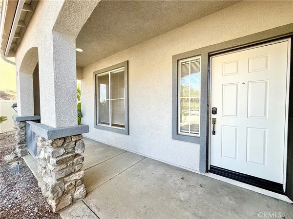 a view of front door with furniture and a window
