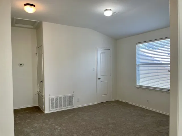 an empty room with a empty space and windows