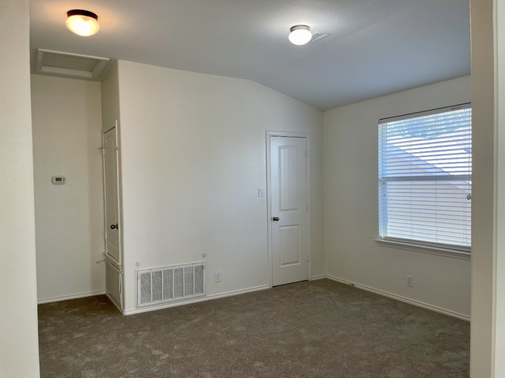 8725 White Ibis Drive Austin, TX 78729 - Photo 15 of 29 an empty room with a empty space and windows