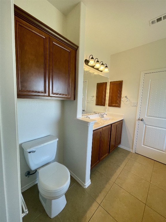 8725 White Ibis Drive Austin, TX 78729 - Photo 20 of 29 a bathroom with a toilet sink and mirror
