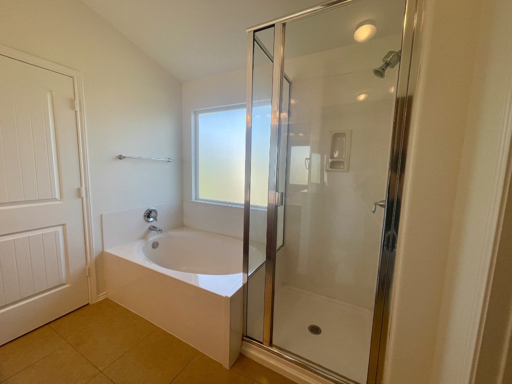 8725 White Ibis Drive Austin, TX 78729 - Photo 21 of 29 a bathroom with a bathtub and a shower