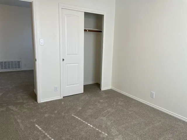 an empty room with closet area